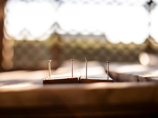 four gray nails on wood