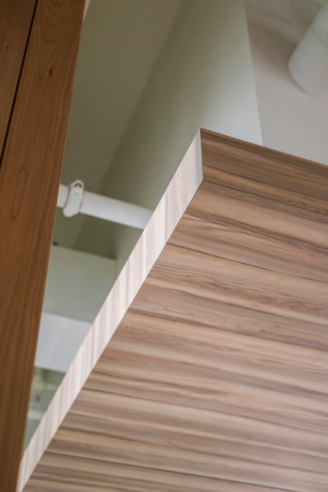 brown wooden cabinet near white wall