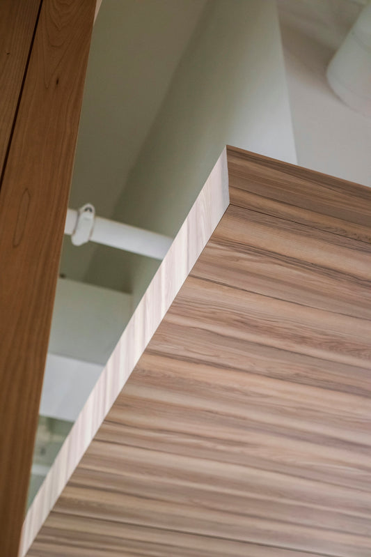 brown wooden cabinet near white wall
