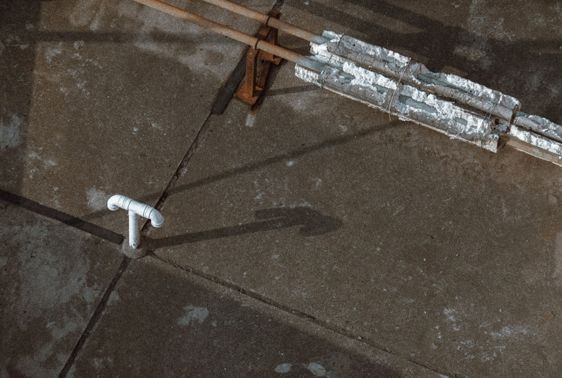 white plastic pipe on gray concrete floor