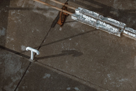 white plastic pipe on gray concrete floor