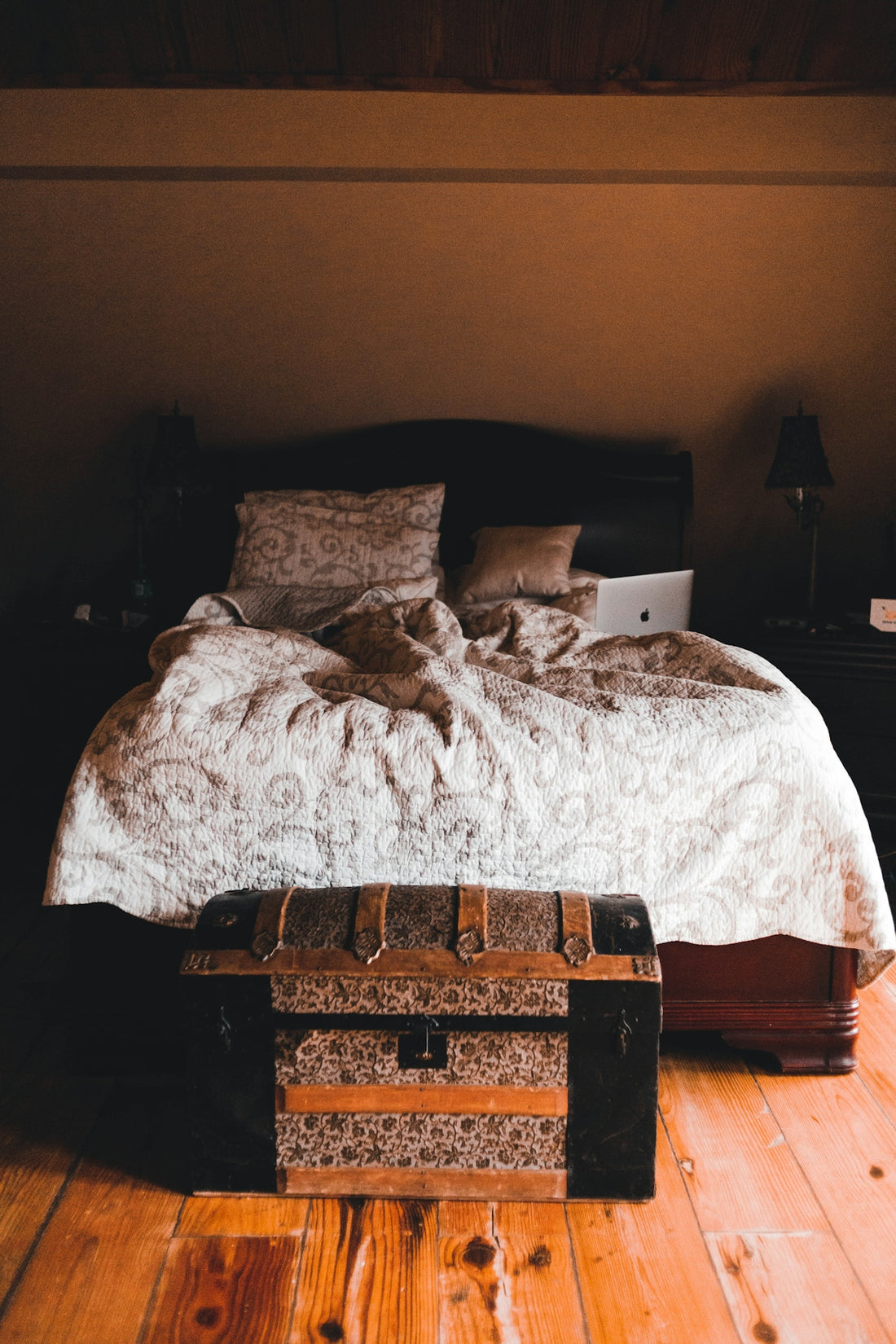 a bed sitting on top of a wooden floor
