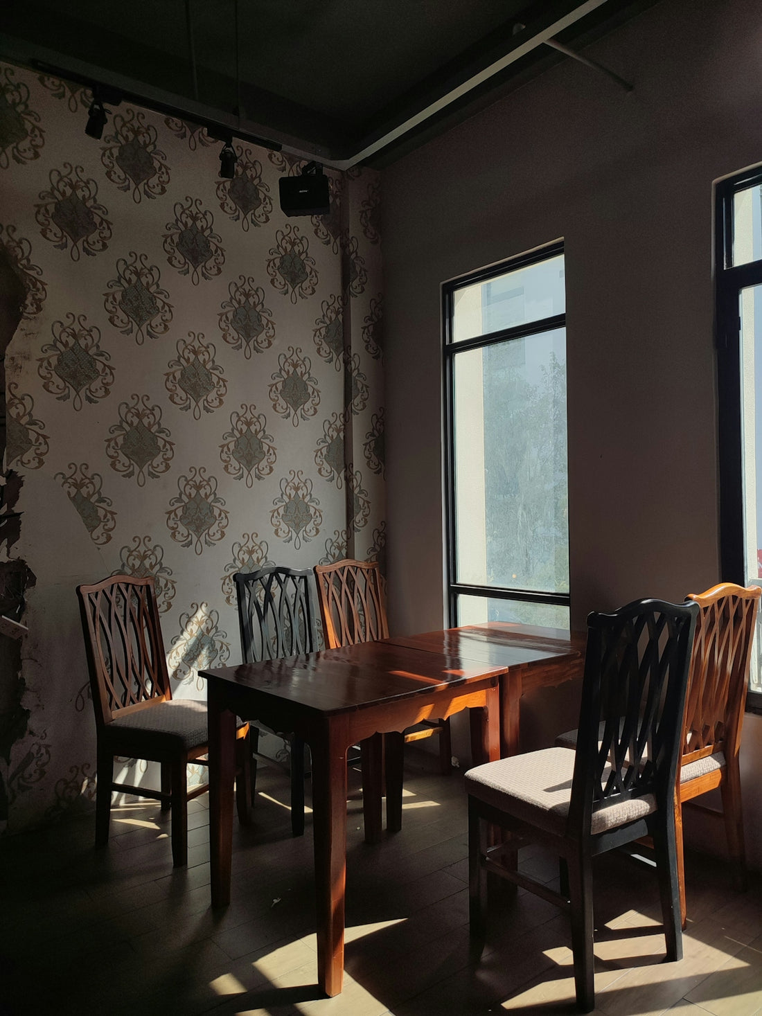 a dining room with a table and four chairs