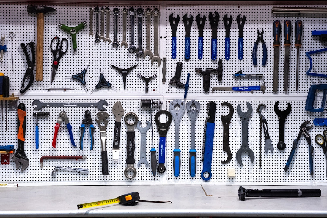 a bunch of tools hanging up on a wall