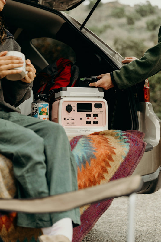 a woman sitting in the back of a car next to a man