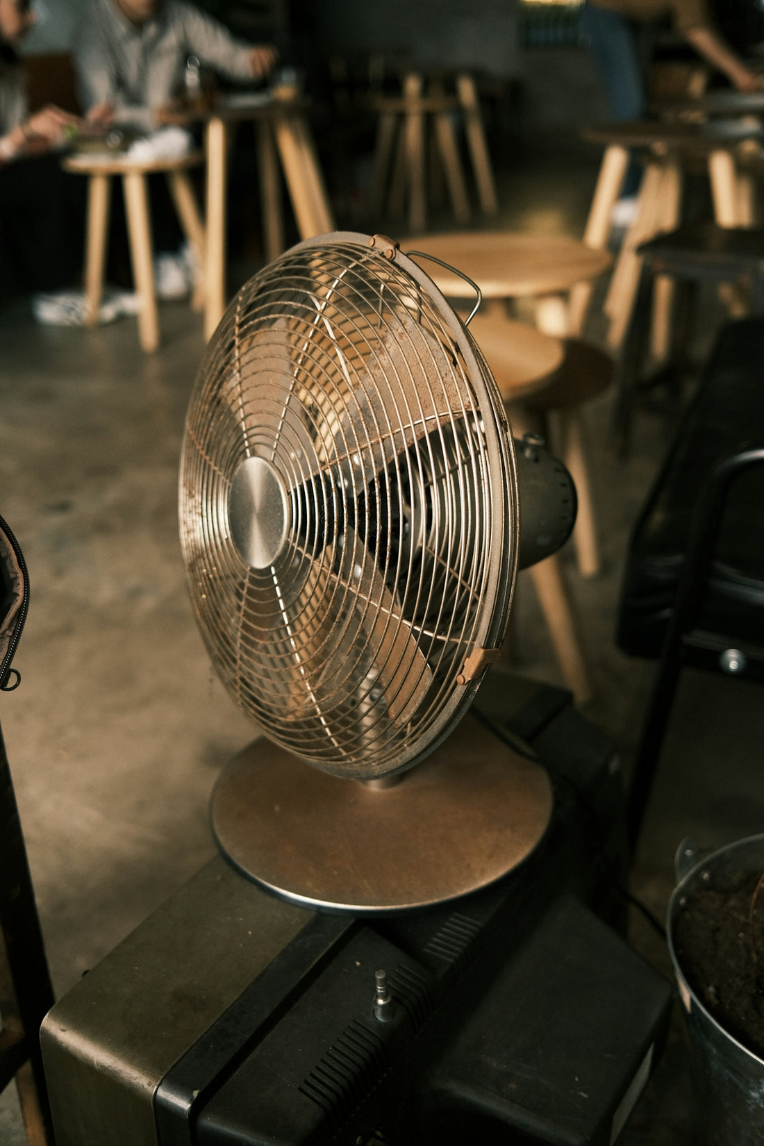 a metal fan sitting on top of a table