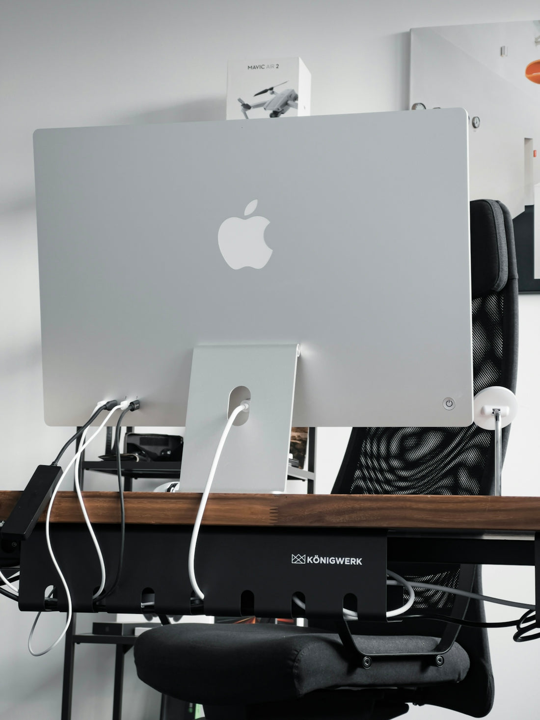 a computer monitor sitting on top of a wooden desk