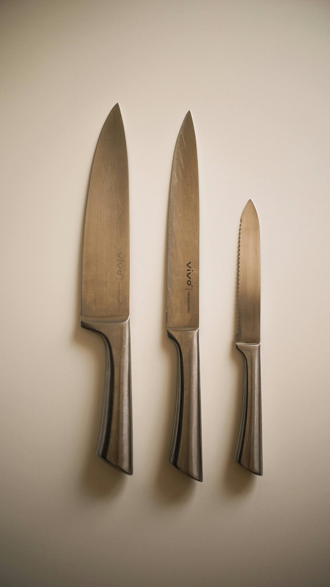 a couple of knives and a knife on a wall