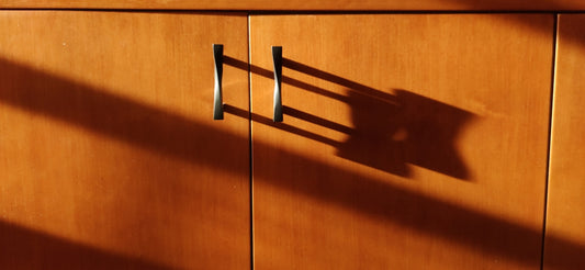 a wooden cabinet with a metal handle on it