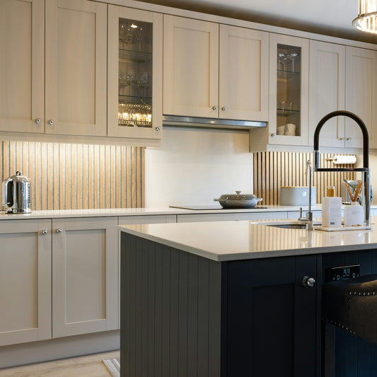 a kitchen with white cabinets and a black island