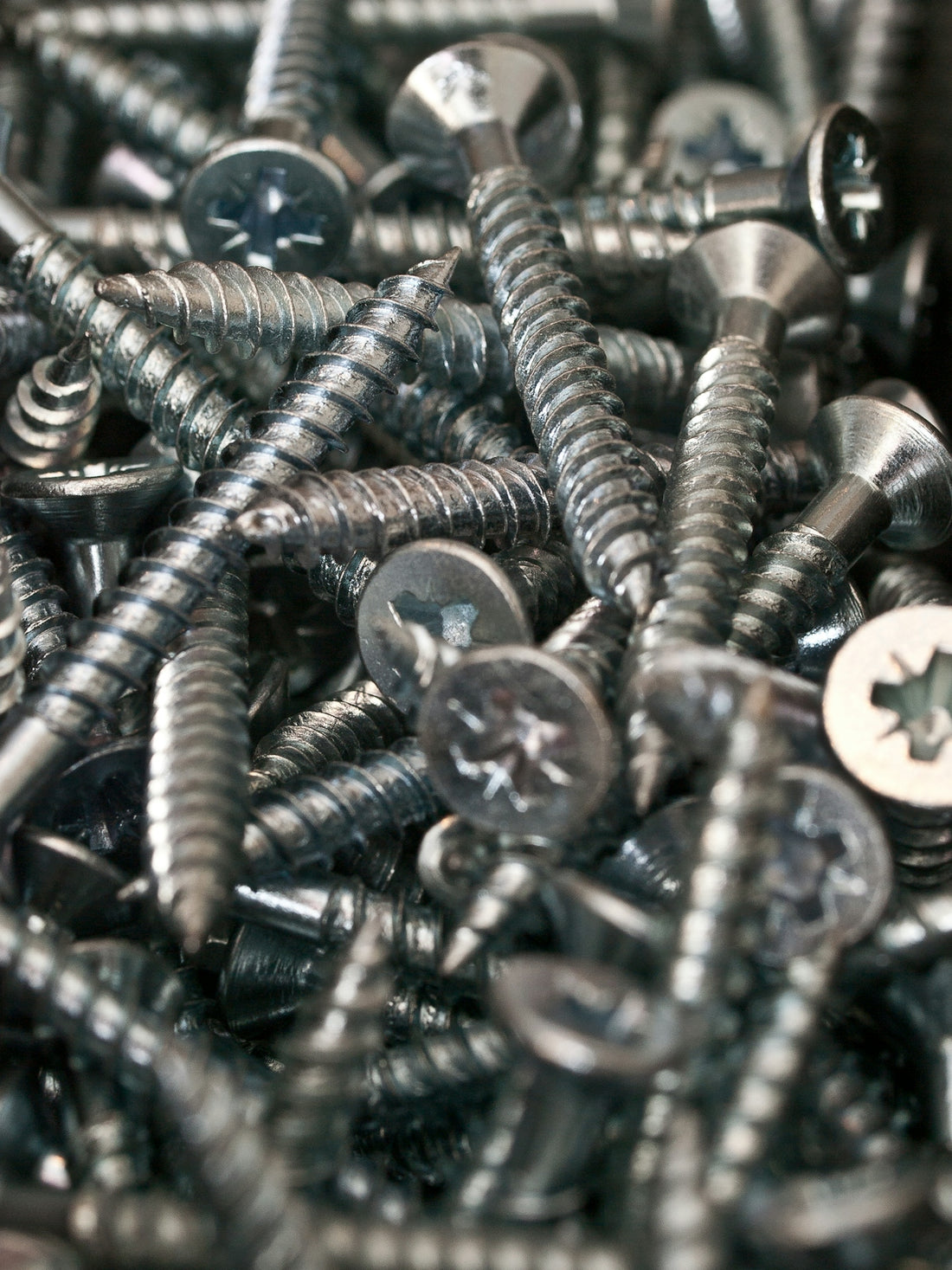 a bunch of screws and nuts in a pile