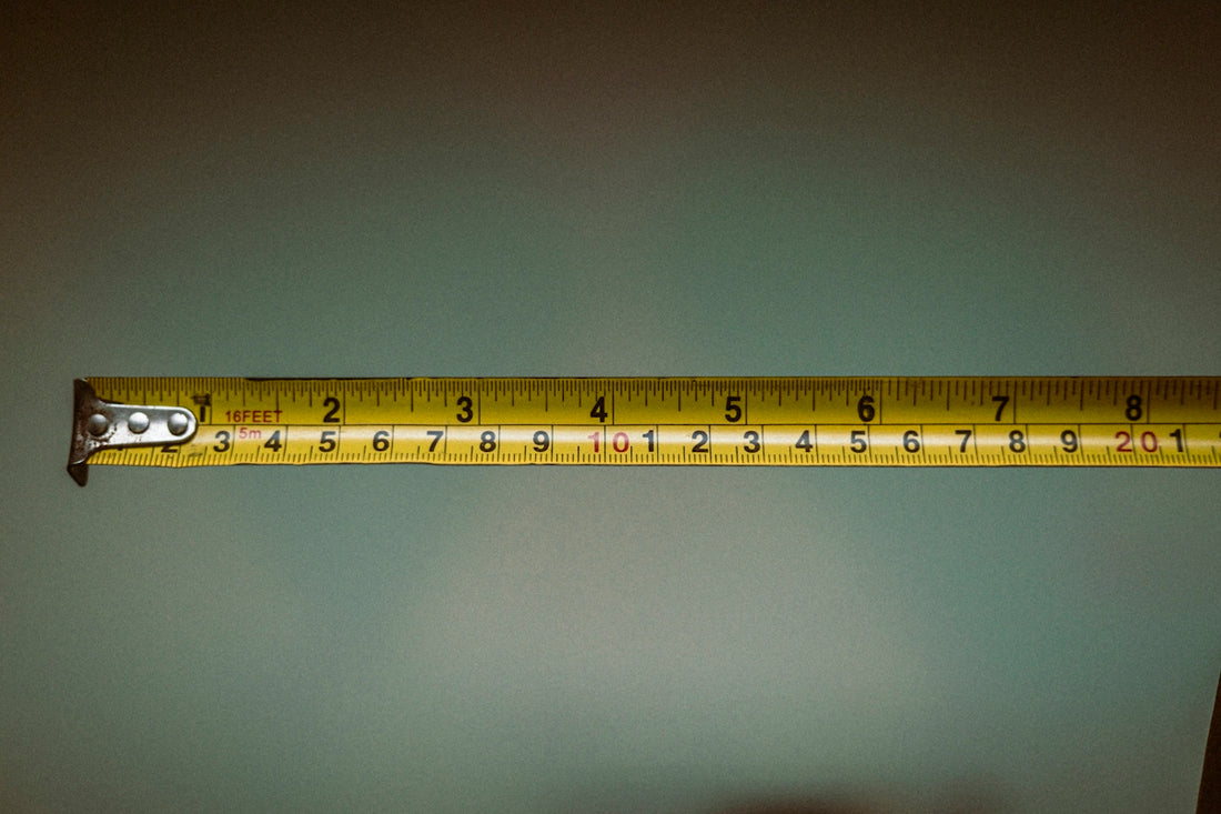 a person holding a tape measure in their hand
