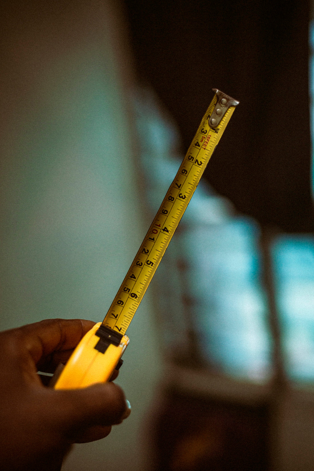 a person holding a tape measure in their hand
