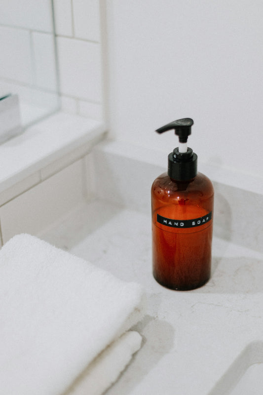 A bottle of soap sitting on a bathroom counter