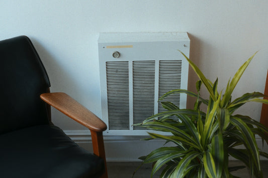 A room with a chair and a heater