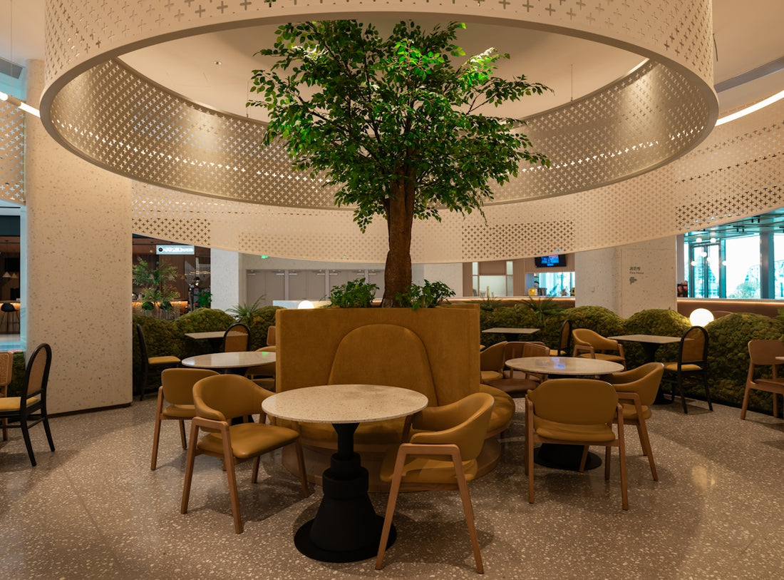 A large room with tables and chairs and a tree