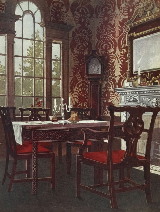 Elegant dining room with antique furniture and wallpaper.
