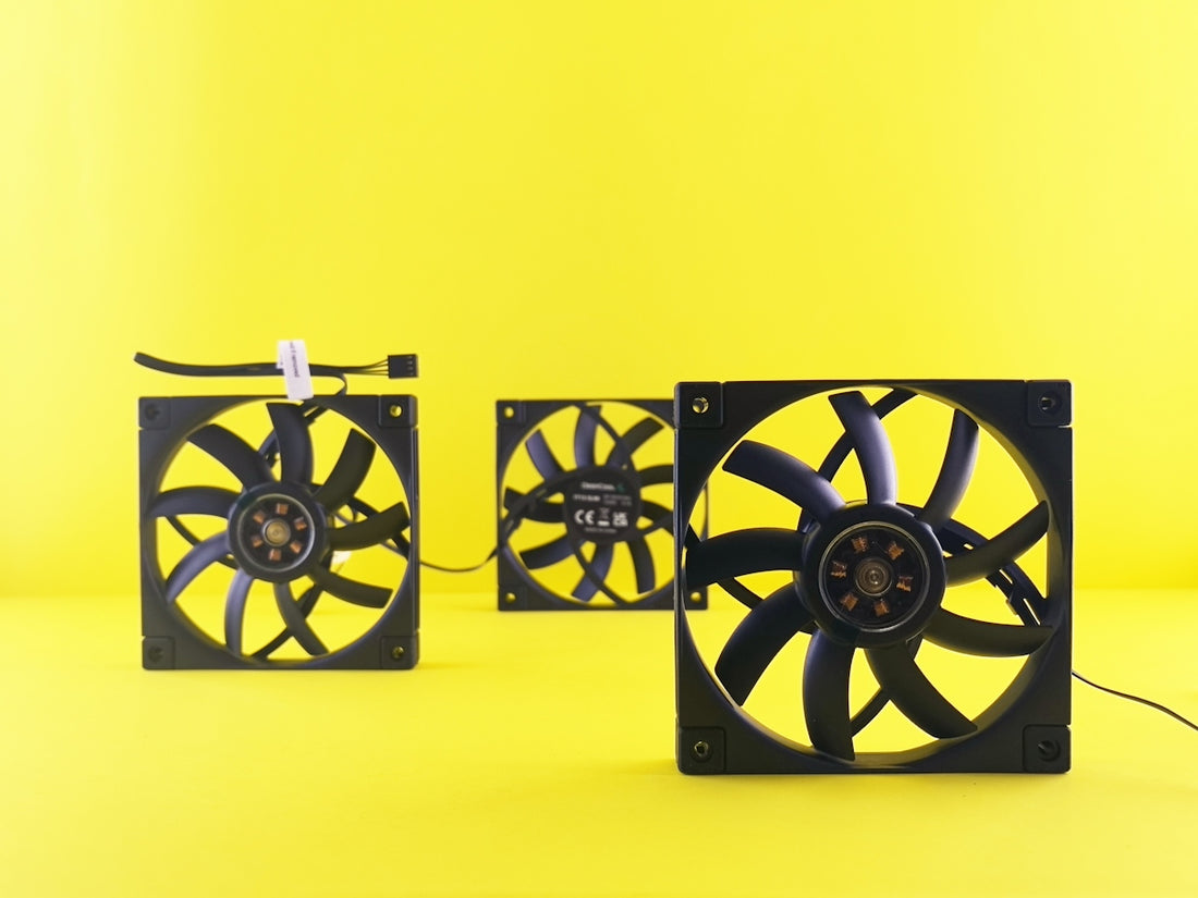 Three black computer fans on yellow background