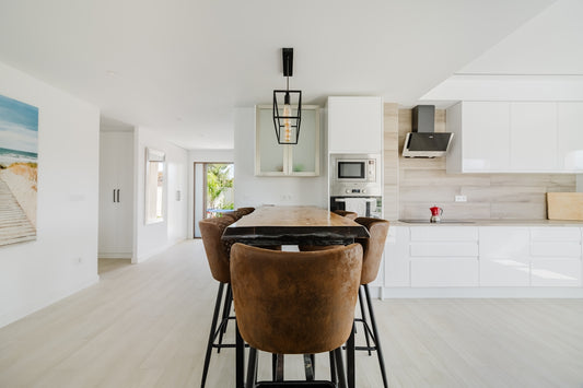 Modern kitchen island with brown chairs and sleek cabinets