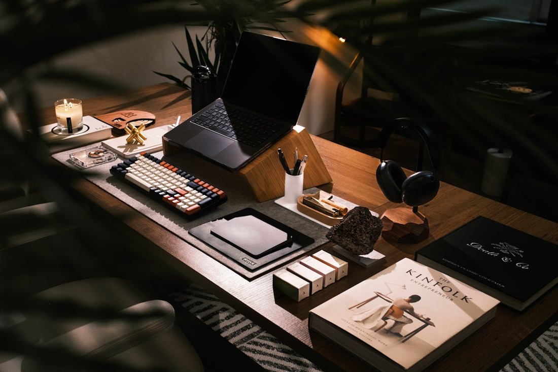 A modern desk setup with laptop and books.