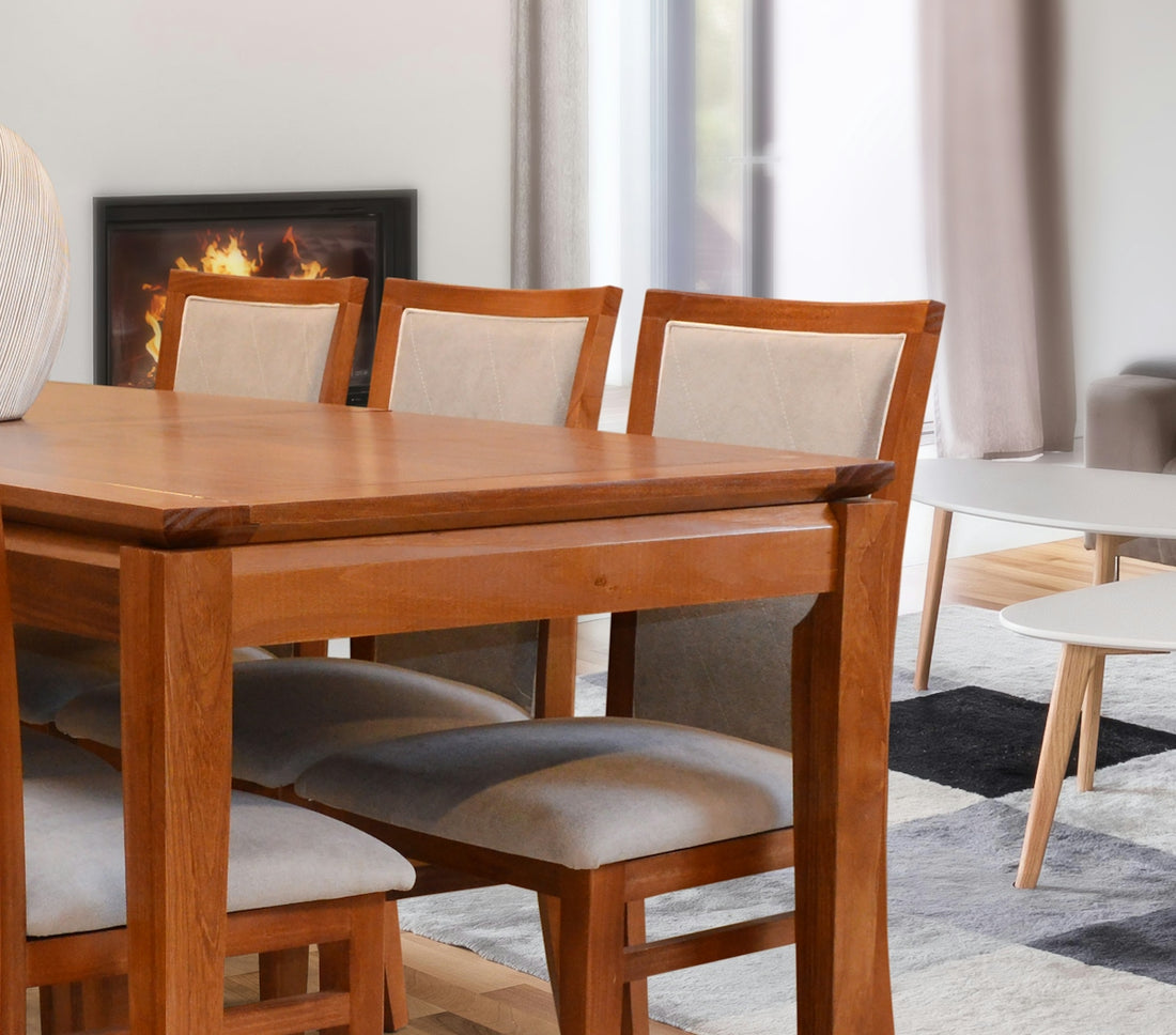 Wooden dining table with upholstered chairs and fireplace