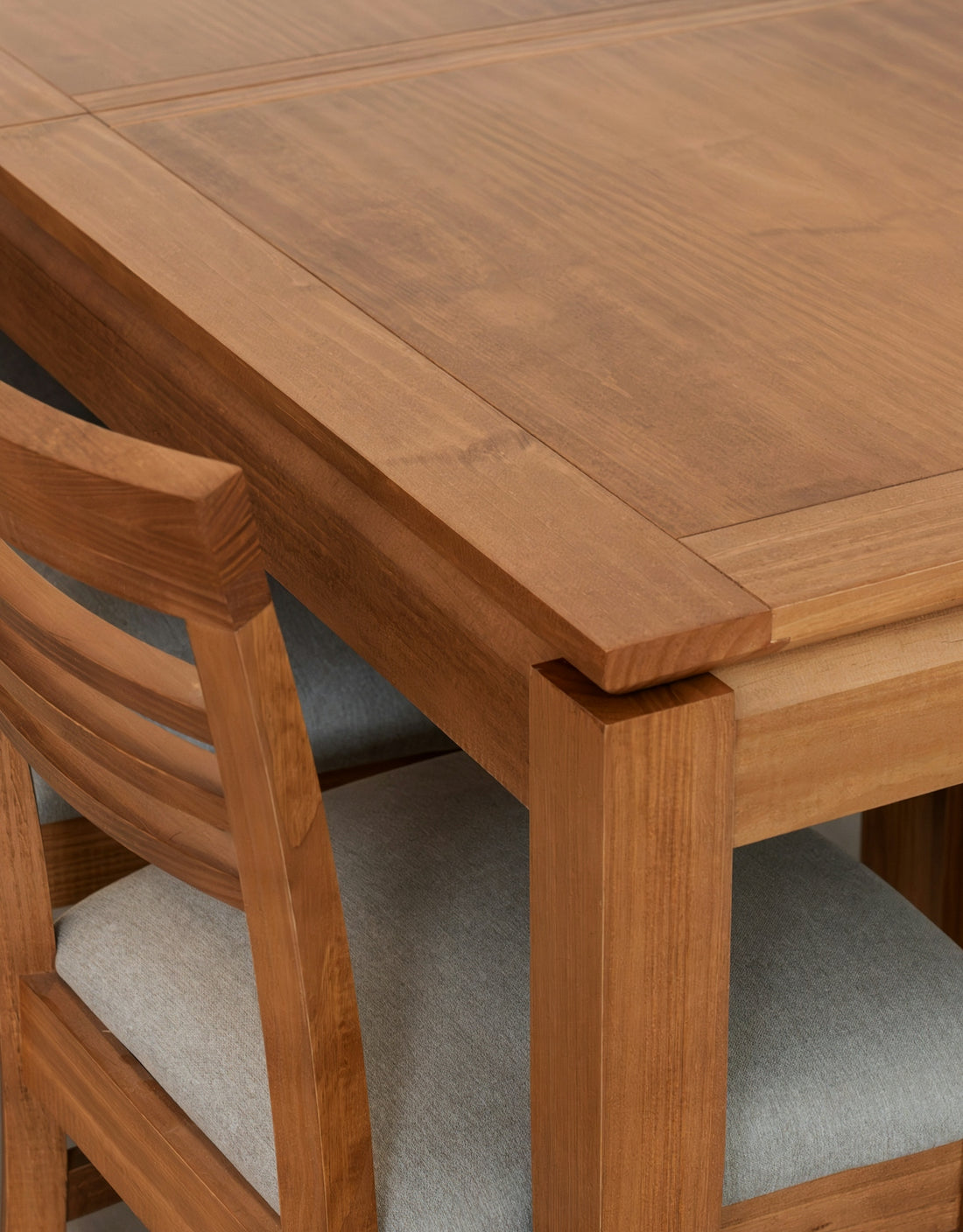 Wooden dining table and chairs with grey upholstery