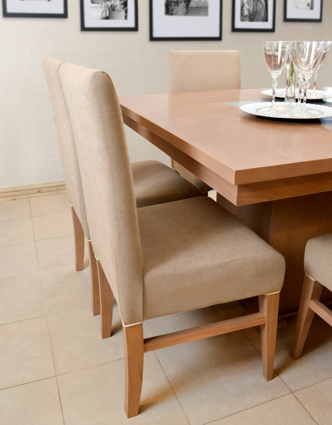 Dining table with upholstered chairs and place settings