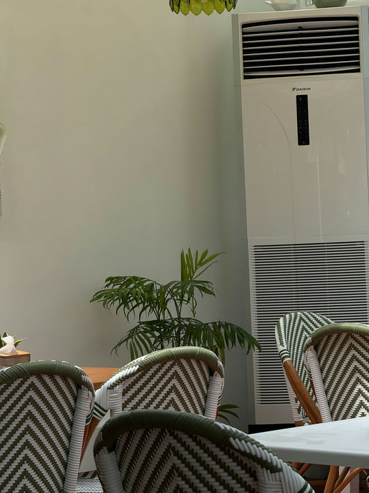 Chairs and tall air conditioner in a room
