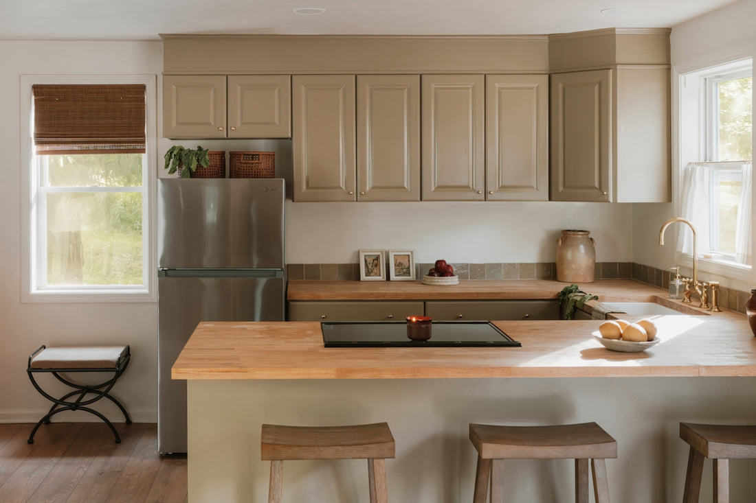 A modern kitchen with light wood countertops and island.