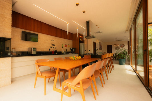 Modern kitchen and dining area with long orange table