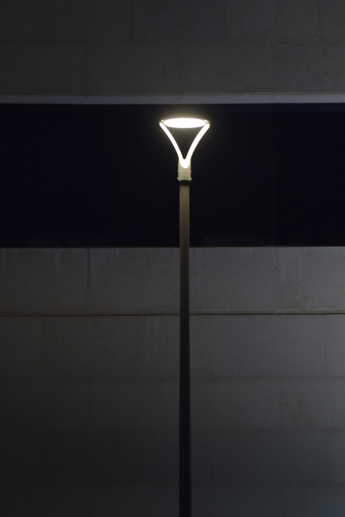 Modern street lamp illuminated at night