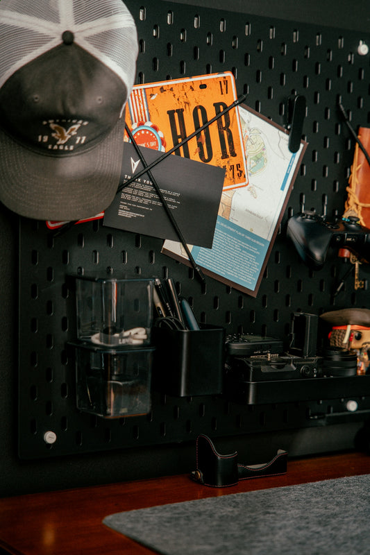 Pegboard organizer with hat, map, and tools.