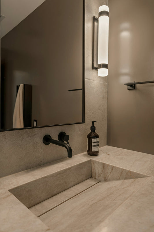 Modern bathroom with stone sink and black faucet