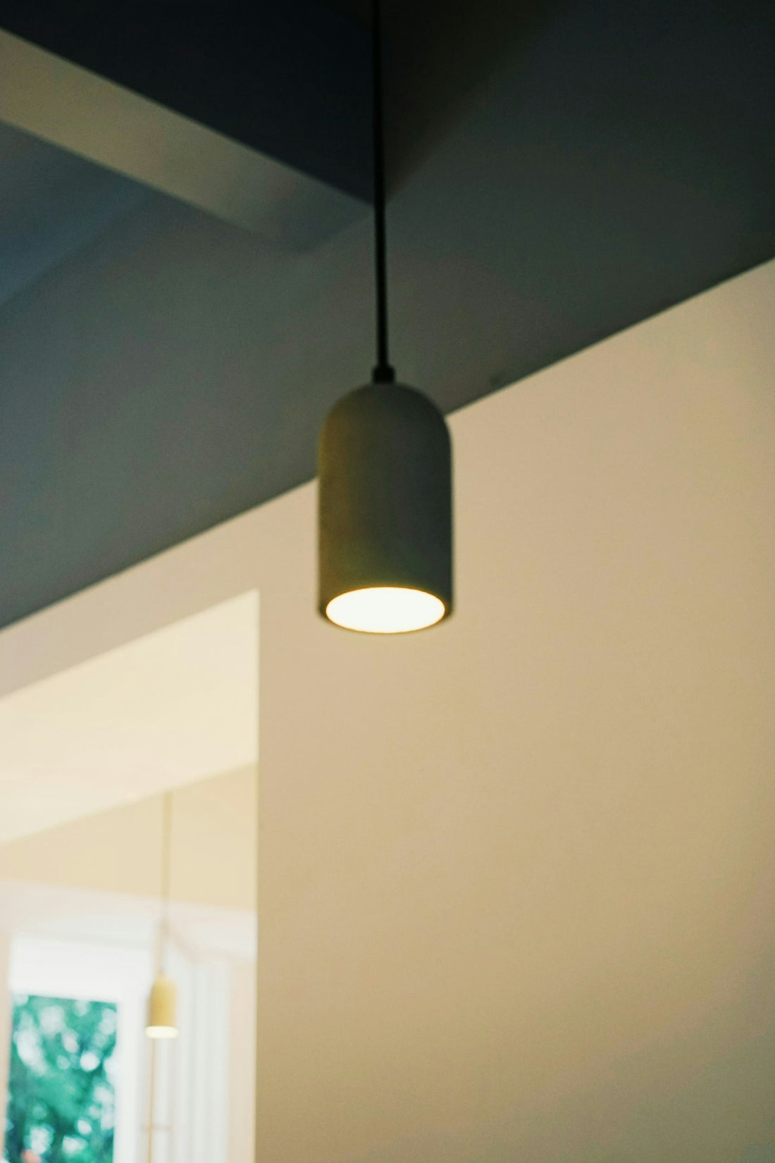 A modern pendant light hangs from the ceiling