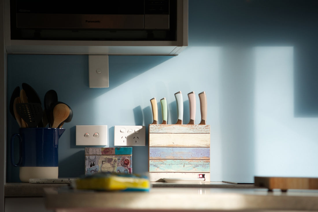 Kitchen counter with knives and utensils in a holder.