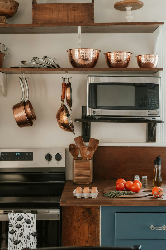 Kitchen counter with tomatoes, eggs, and utensils