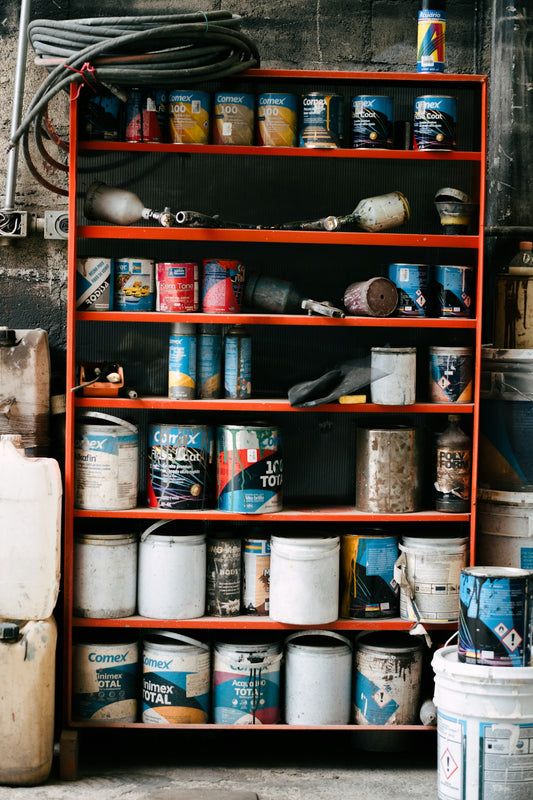 Shelving unit filled with paint cans and containers