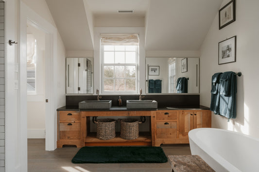 A modern bathroom with double sinks and a bathtub.