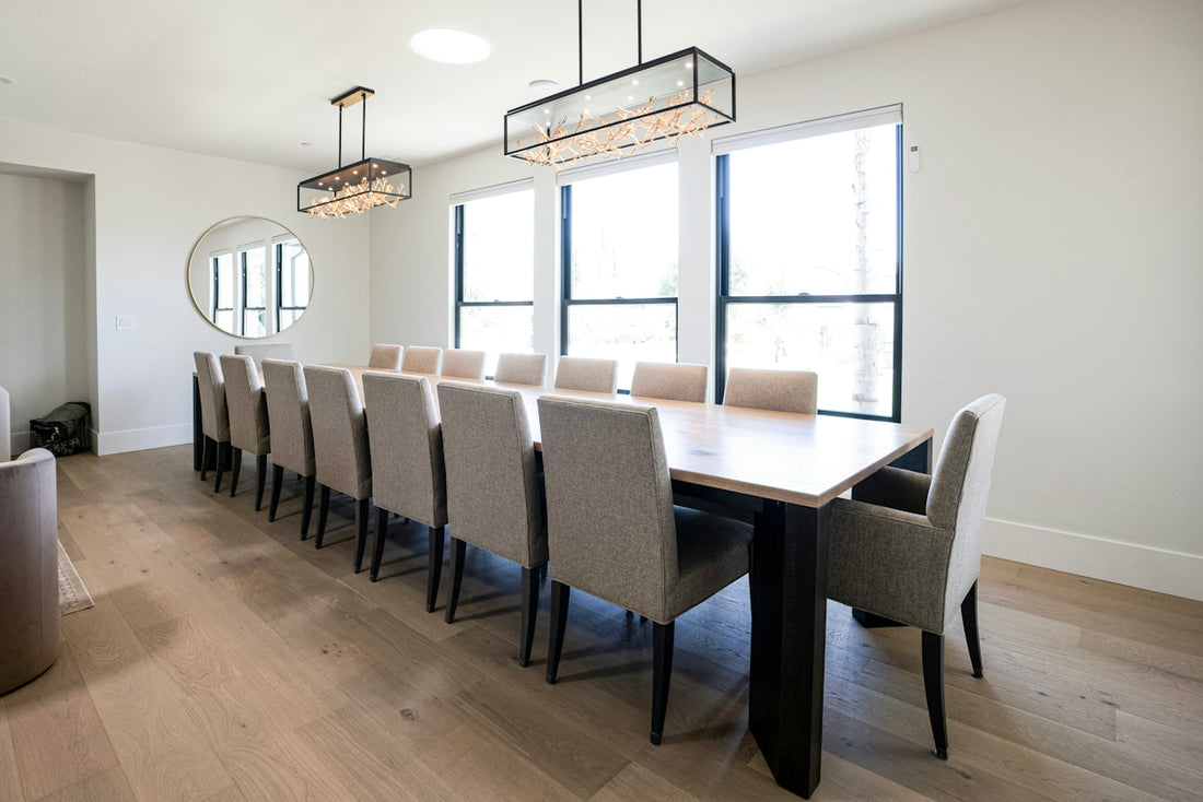 Long dining table with many chairs in a bright room