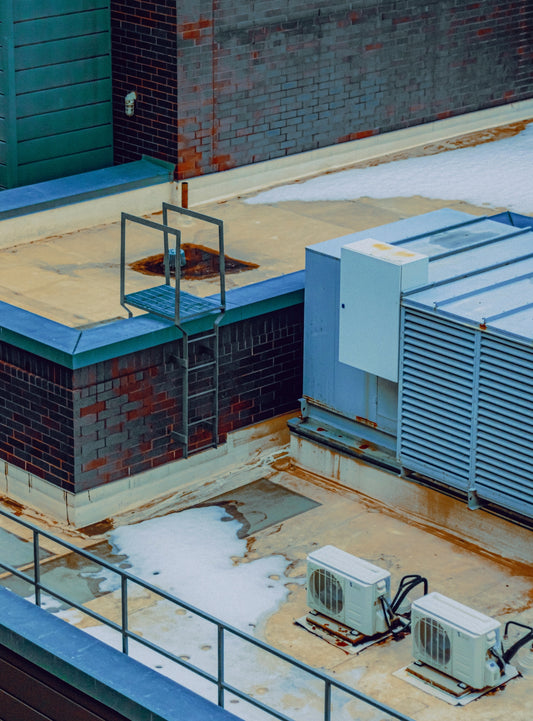 Rooftop with hvac units and snow patches