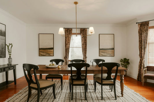 A formal dining room with a wooden table and chairs