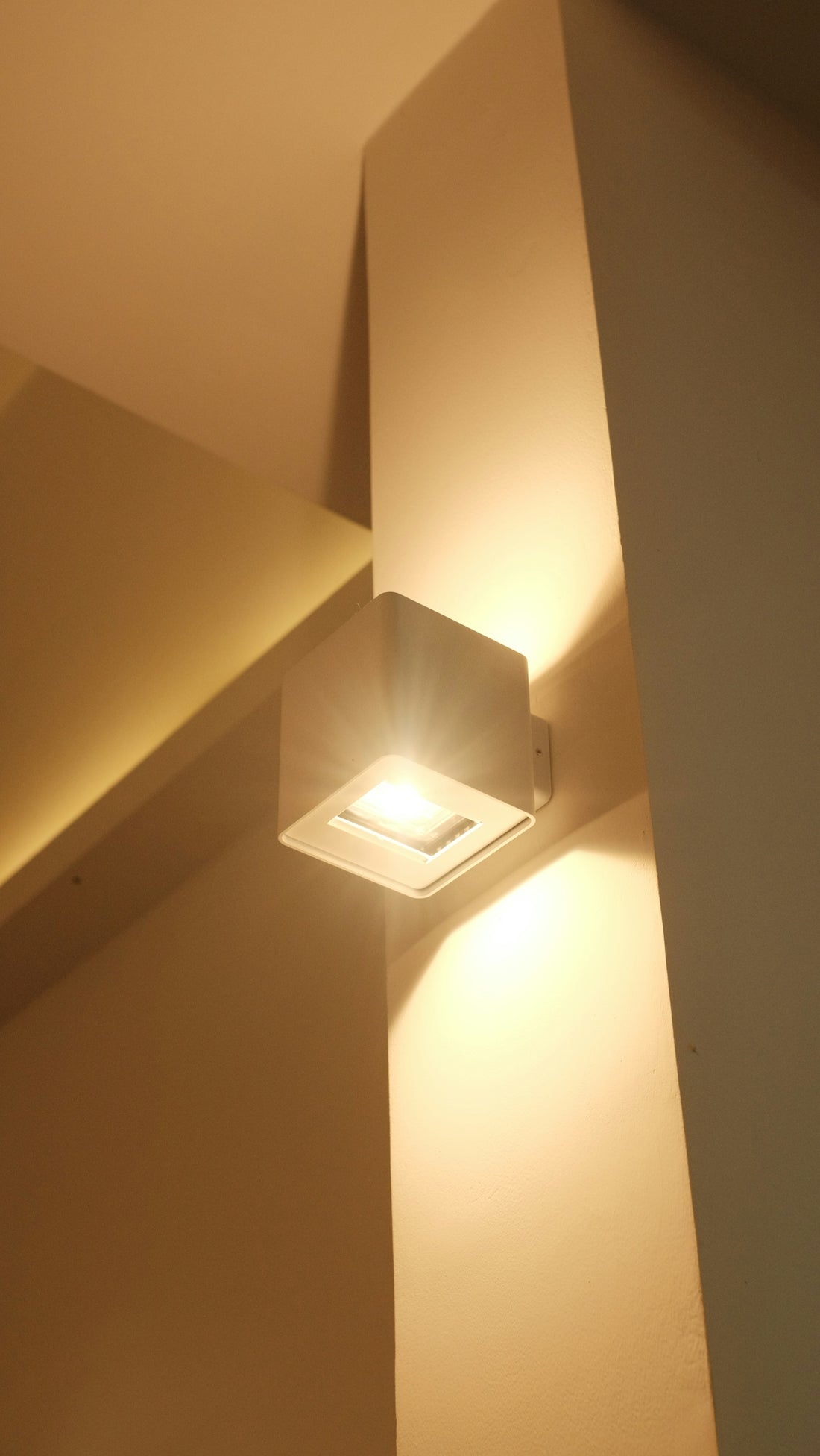 Modern cube wall light illuminating a corner