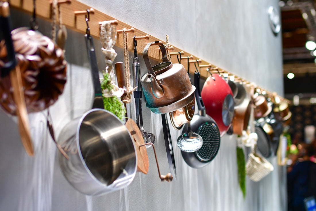 Various kitchen utensils hanging on a rack.