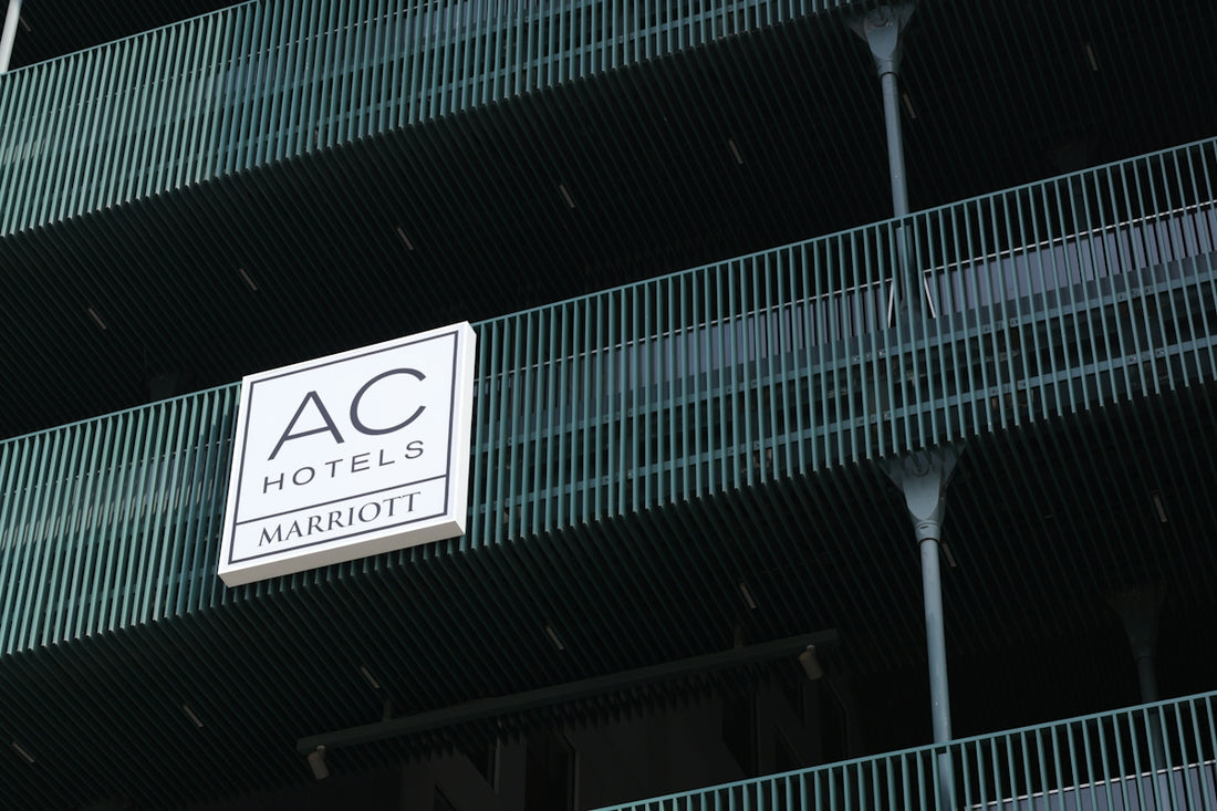 Ac hotels marriott sign on a building with green railings