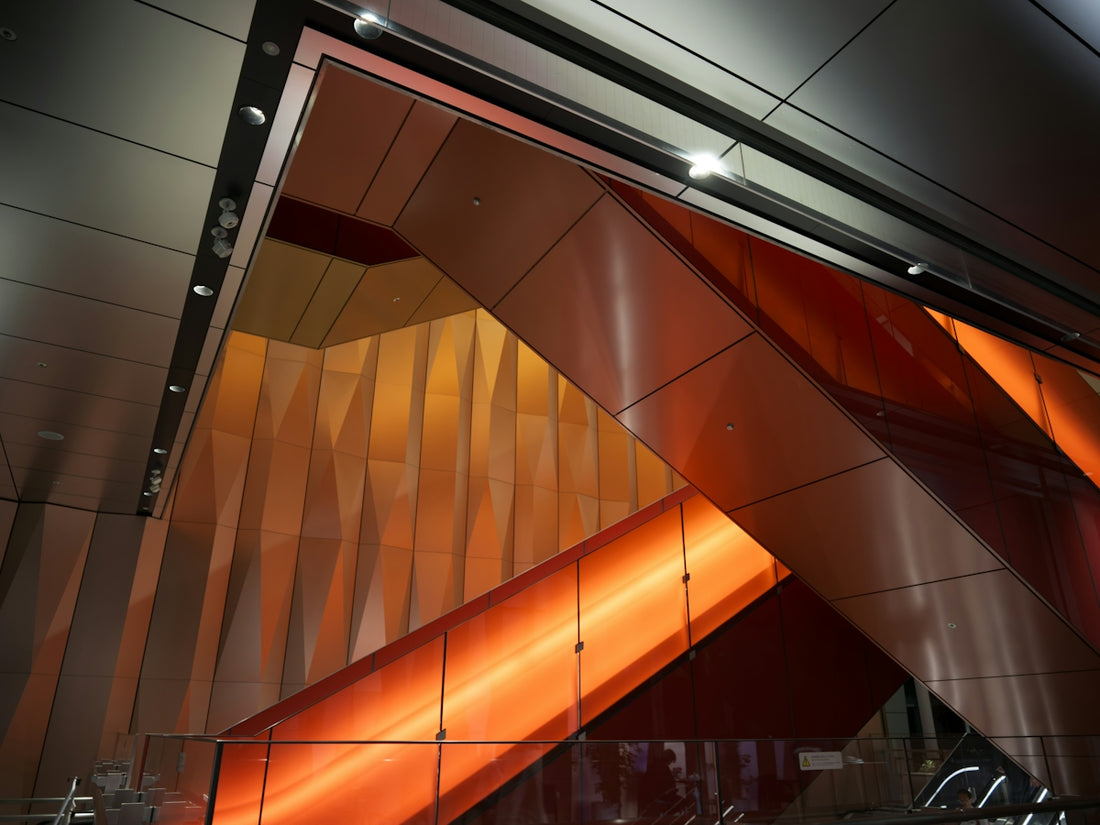 Modern escalators with warm orange and yellow lighting