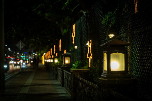 Street at night with glowing lanterns and decorative lights