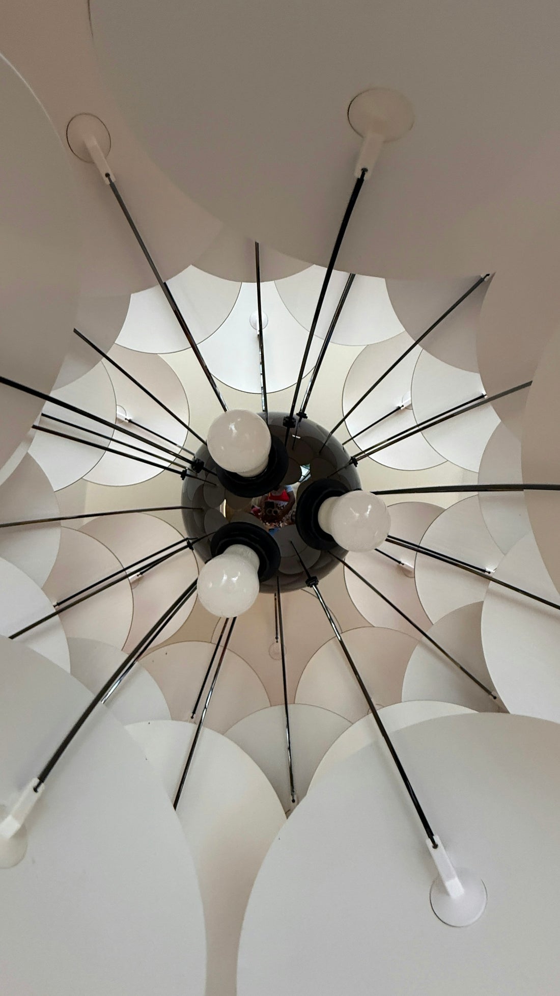Modern chandelier with radiating white elements and bulbs