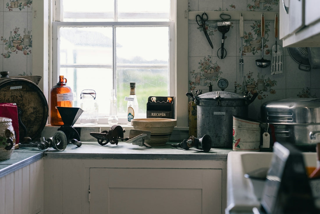 A vintage kitchen counter filled with old tools and appliances