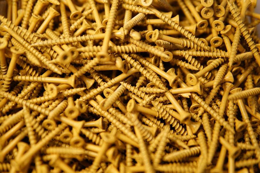 A pile of golden-colored screws